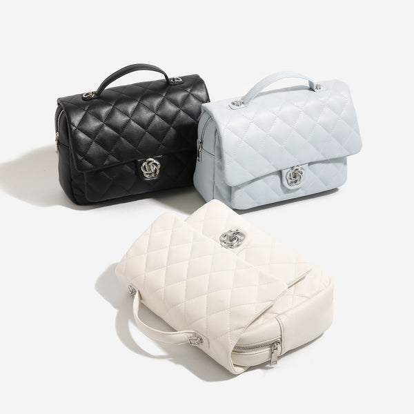 Diamond-quilted flap backpack handbag with silver-tone flower turn-lock, top handle, and dual shoulder straps, detail view 2