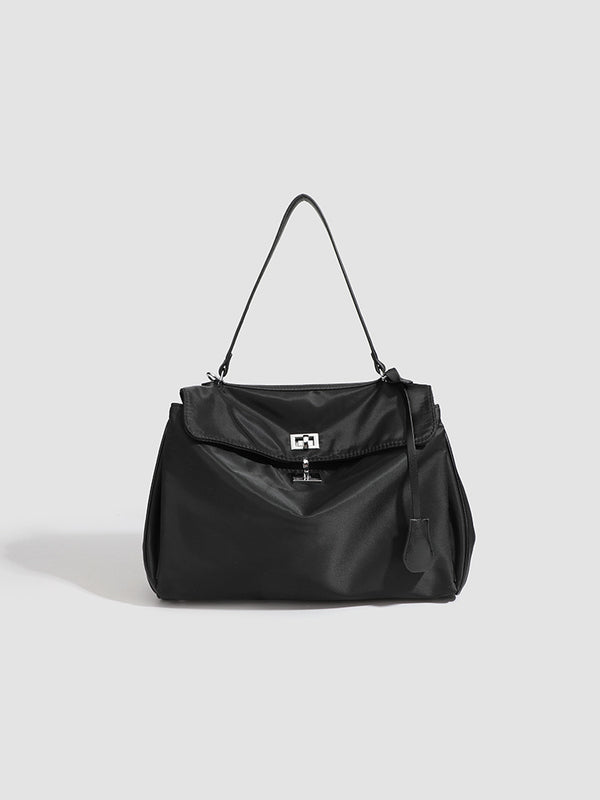 Structured black leather-look flap satchel bag with silver turn-lock hardware and top handle, detail view 11