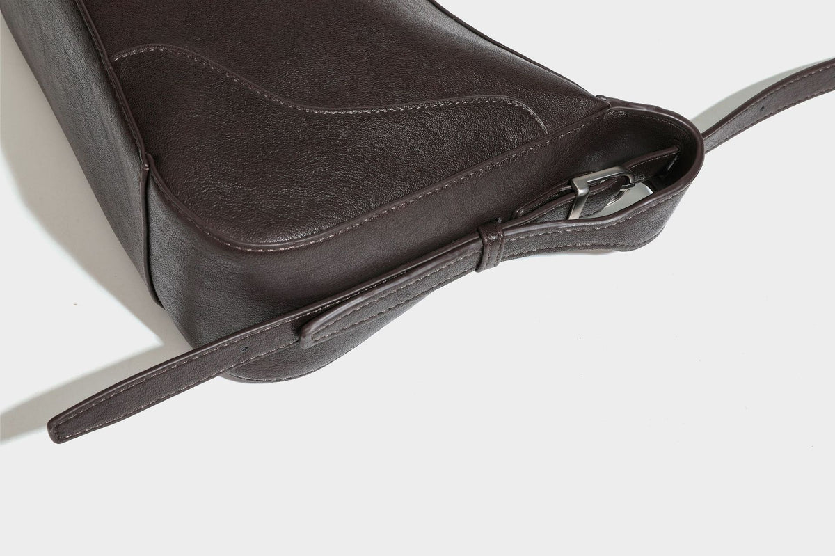 Slouchy crescent hobo shoulder bag in dark brown pebbled leather-look finish with zip top and long shoulder strap, detail