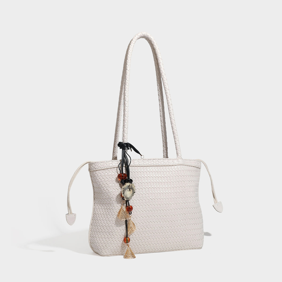 Structured woven leather-look tote bag in dark brown with long shoulder straps, side drawstring ties, and gold filigree