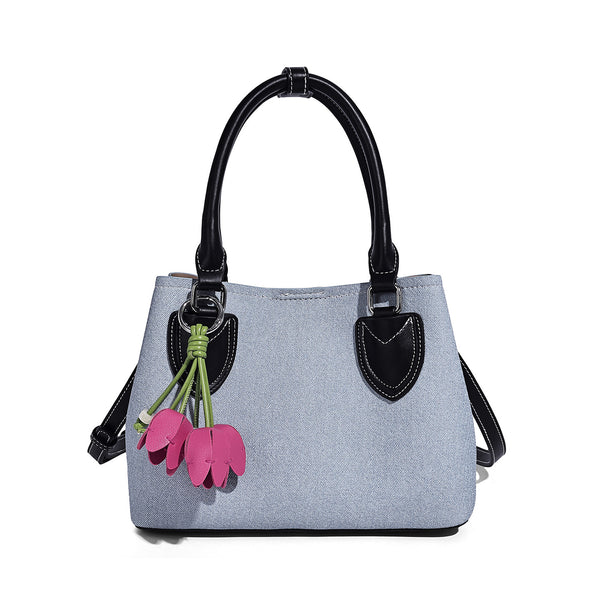 Structured light-blue denim-look tote bag with black leather-look handles, white contrast stitching, silver-tone hardware