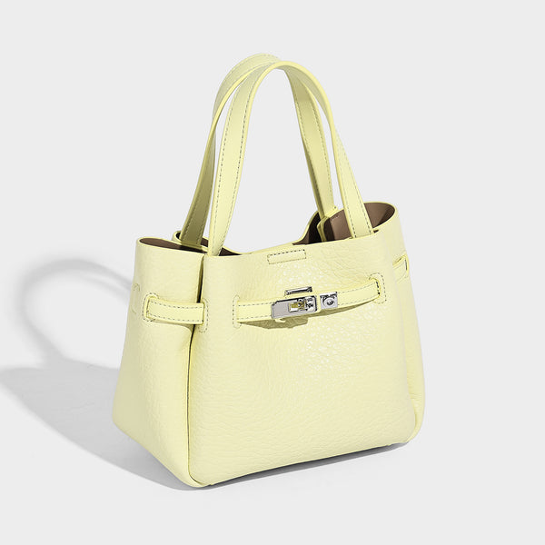 Small structured pebbled bucket tote with double top handles, silver turn-lock hardware, and detachable shoulder strap