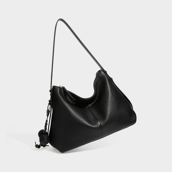 Slouchy hobo shoulder bag with pebbled leather-look finish, zip-top closure, gold-tone hardware, and hanging bead charm