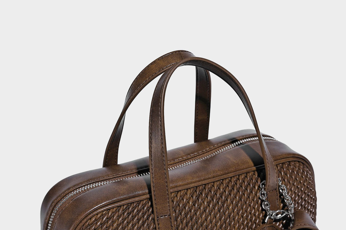 Structured woven-texture front top-handle handbag with zip closure, dual handles, detachable shoulder strap, and matching