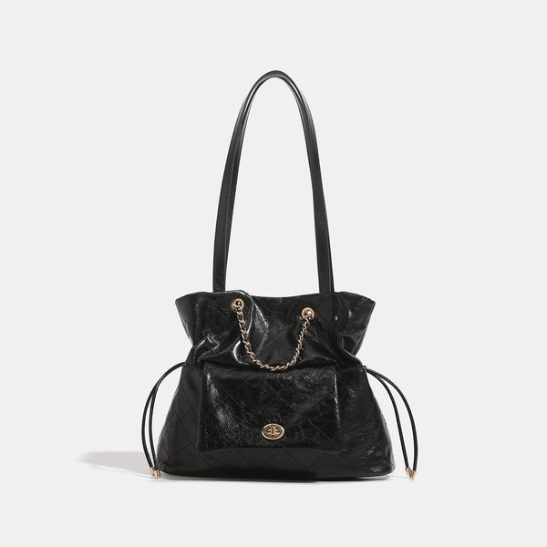 Black glossy diamond-quilted bucket tote bag with gold-tone chain accent, turn-lock front flap pocket, drawstring side ties