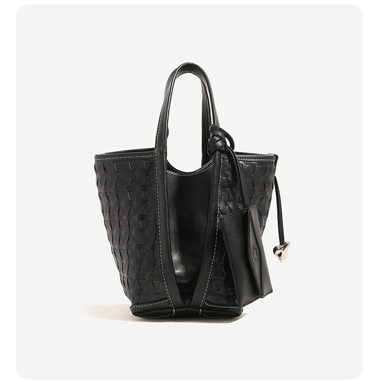 Woven embossed leather-look bucket bag with triangular texture pattern, gold-tone hardware, and attached mini snap pouch