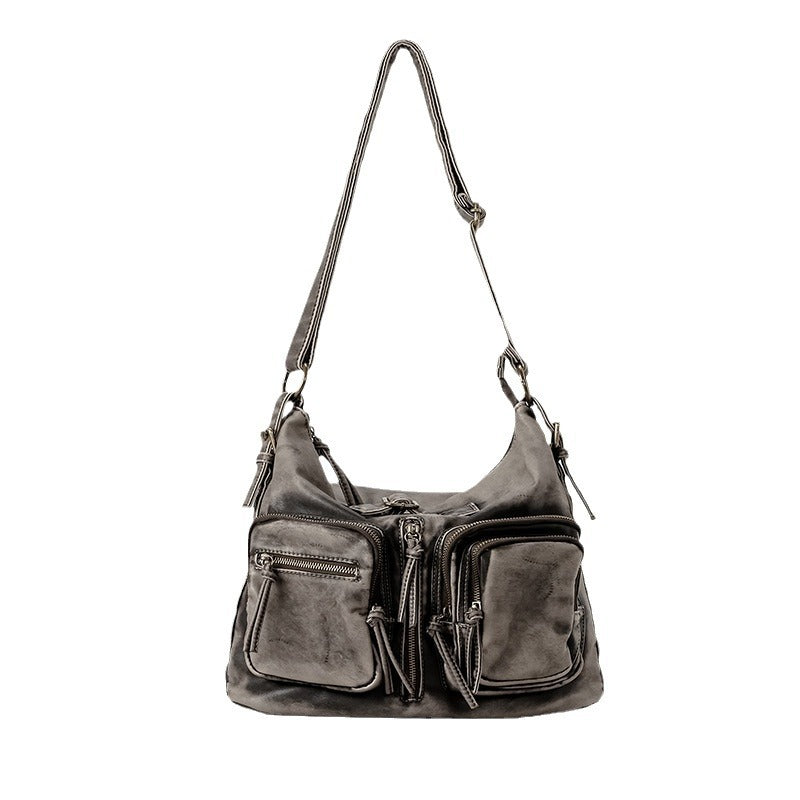 Distressed gunmetal gray hobo shoulder bag with multiple front zip pockets and adjustable crossbody strap, detail view 5