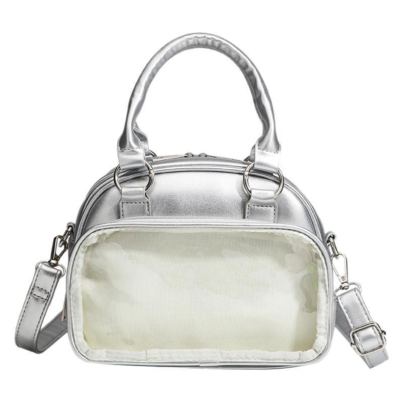 Structured mini bowling barrel bag with clear front pocket, dual top handles, and detachable crossbody strap in glossy