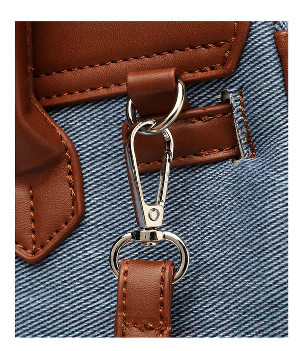 Small structured trapezoid satchel bag with smiling face motif, pom-pom accents, brown leather-look trim, silver-tone, detail