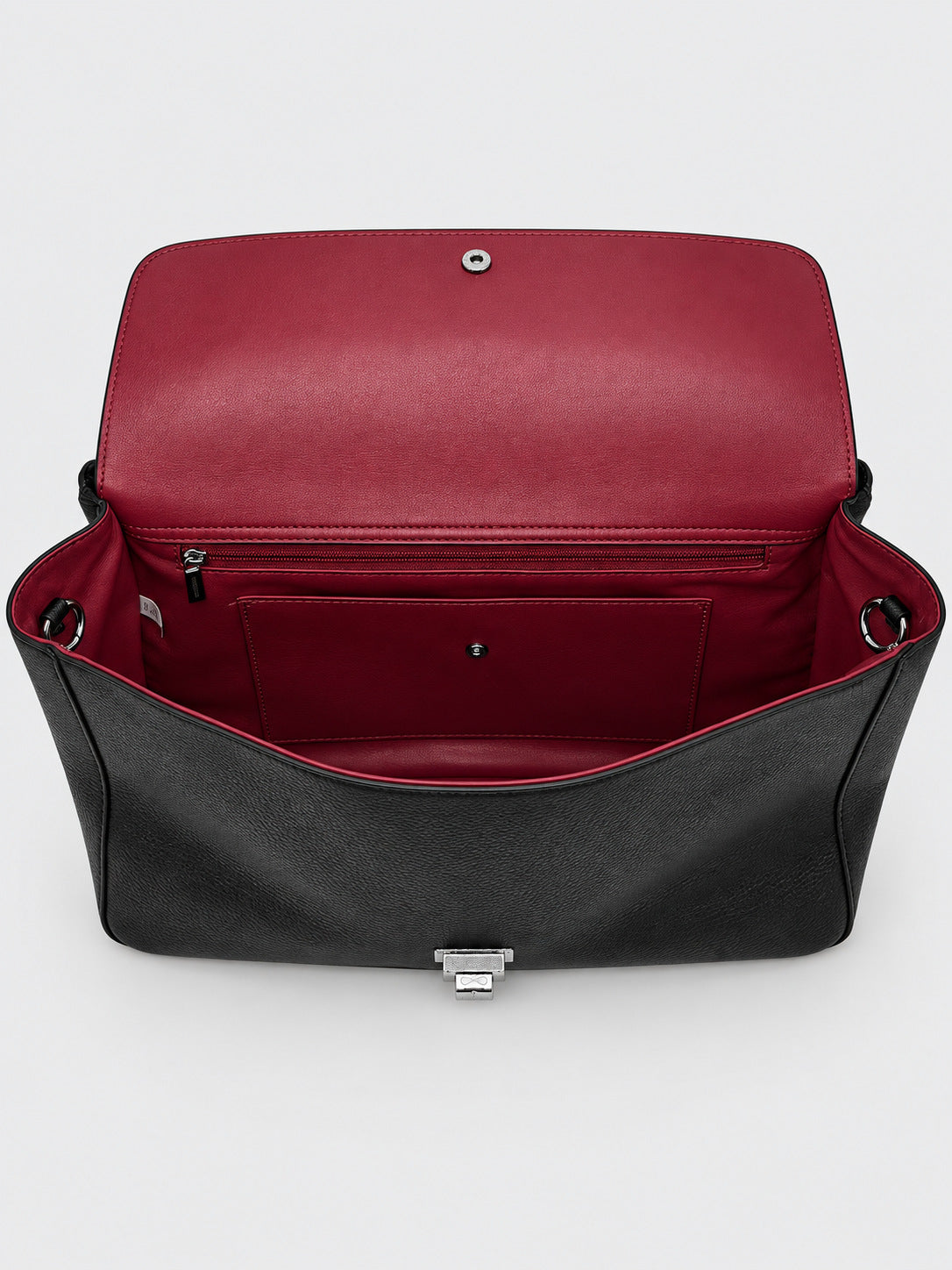 Structured black flap shoulder bag with pebbled texture, silver-tone turn-lock closure, and adjustable single shoulder strap