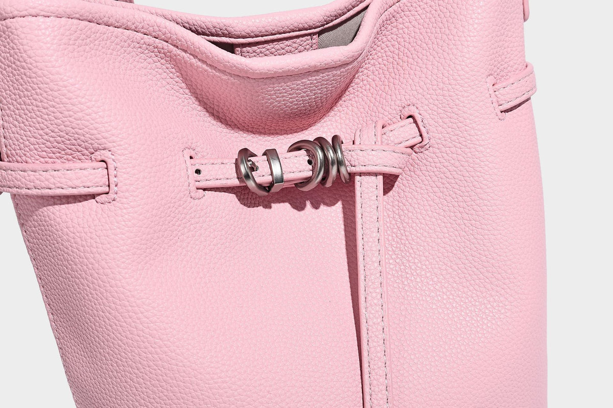 Small pebbled leather-look bucket bag with front drawstring toggle hardware and long adjustable shoulder strap, detail view