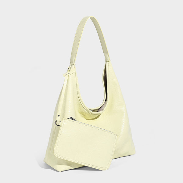 Slouchy hobo shoulder bag in pale yellow glossy pebbled leather-look finish with single shoulder strap and detachable front