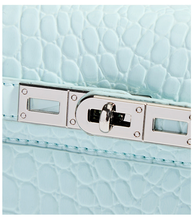 Compact structured flap satchel with glossy crocodile-embossed leather-look finish, silver-tone turn-lock hardware, and