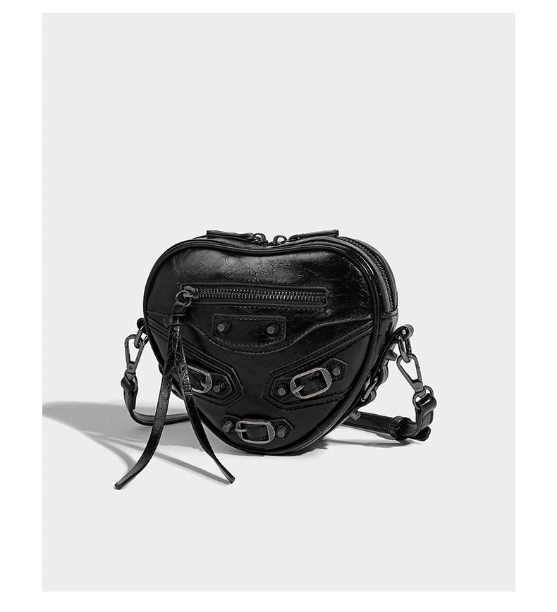 Mini heart-shaped crossbody bag with glossy crinkled finish and moto buckle hardware, detail view 10