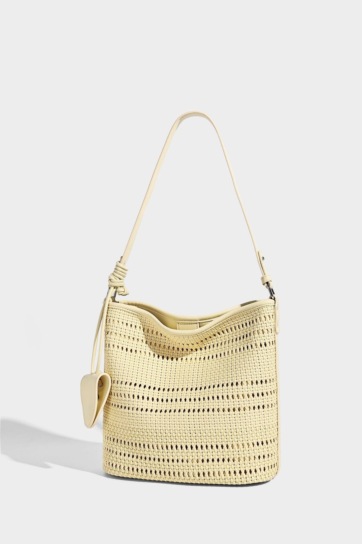 Handwoven open-weave shoulder bag with leather-look trim, knotted adjustable strap, and clip-on sunglasses sleeve pouch