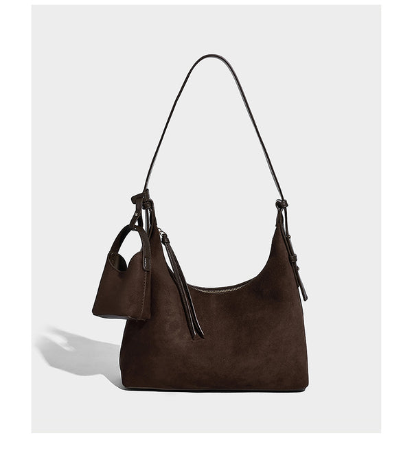 Dark brown suede-look hobo shoulder bag with top zip closure, adjustable strap, and small detachable mini pouch, detail view