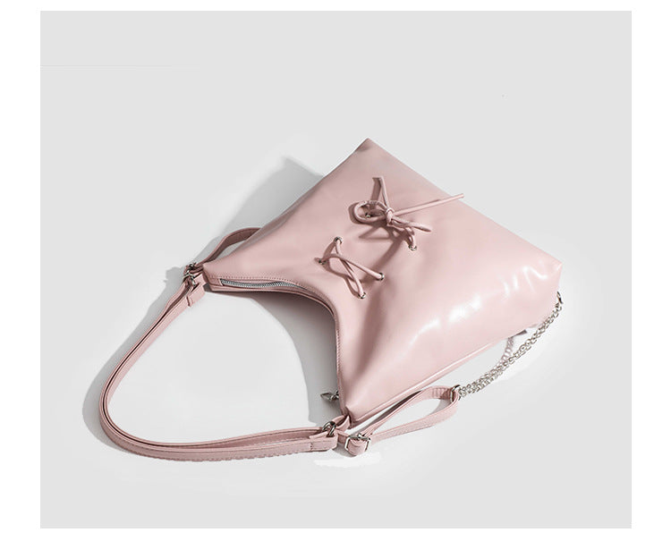 Glossy leather-look hobo shoulder bag with front bow lacing detail and silver-tone chain strap, detail view 15