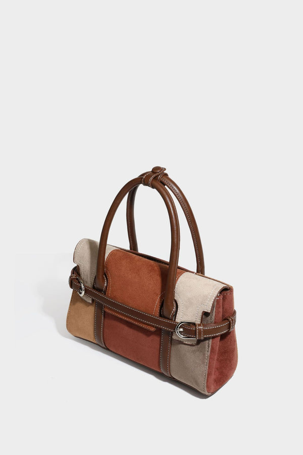 Structured color-block satchel bag in brown, rust, beige, and taupe suede-look panels with white topstitching, front buckle