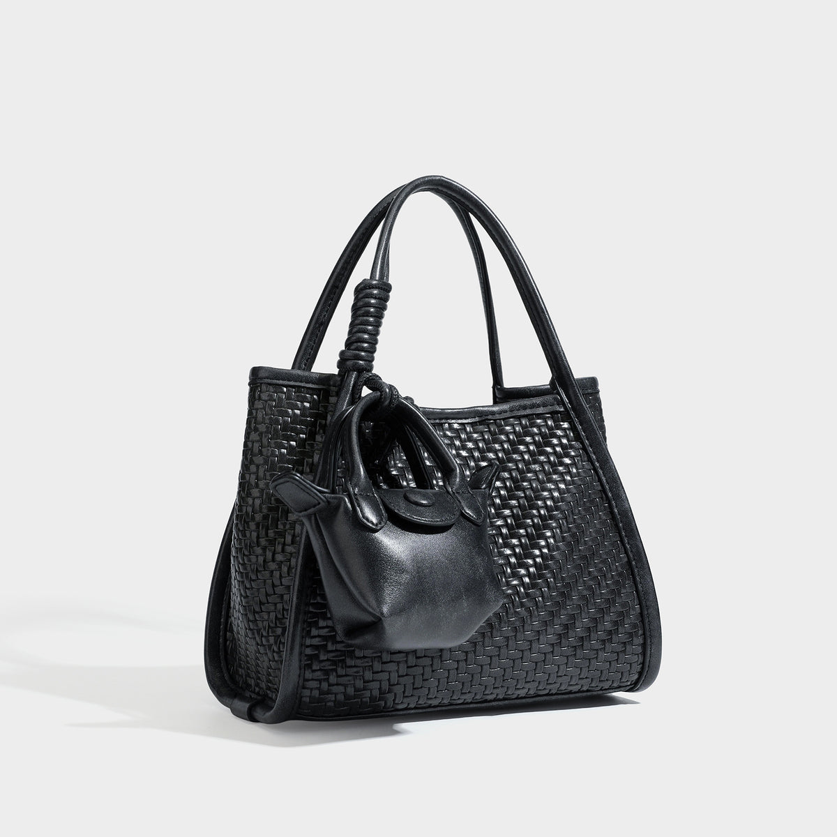 Strukturierte Tote Bag mit Webstruktur in Braun, glatten Besätzen in Lederoptik, geknoteten Tragegriffen und befestigtem Mini-Beutel mit Kordelzug