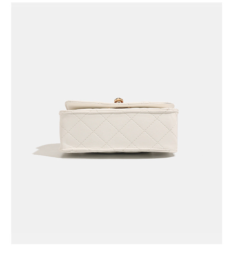 Small structured quilted flap crossbody bag with gold-tone turn-lock closure and chain strap, detail view 13