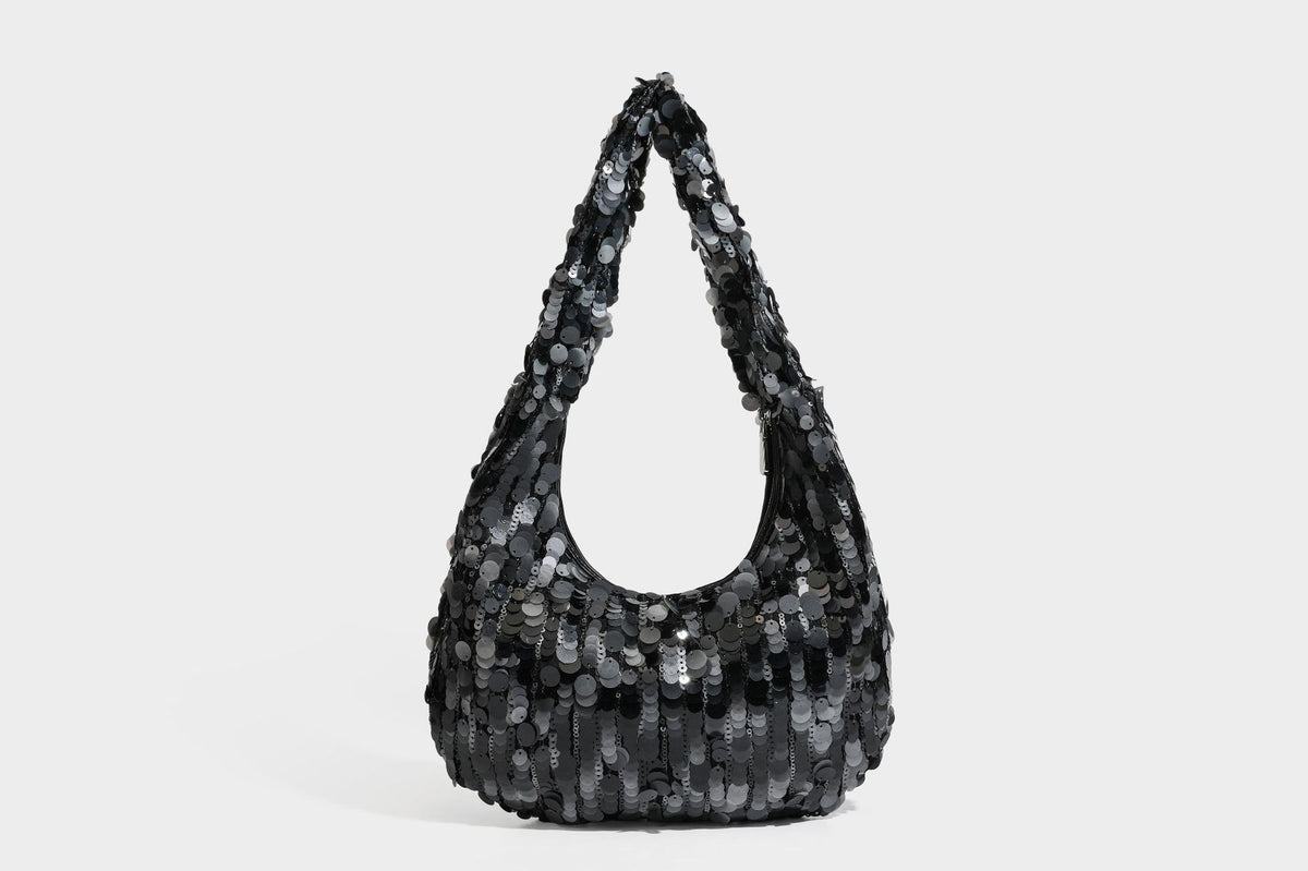 Slouchy crescent hobo shoulder bag covered in overlapping reflective sequin discs with a single integrated strap and top-zip