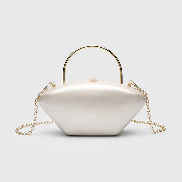 Shell-shaped pearlescent top-handle clutch bag with arched gold-tone metal handle and gold chain strap, front view