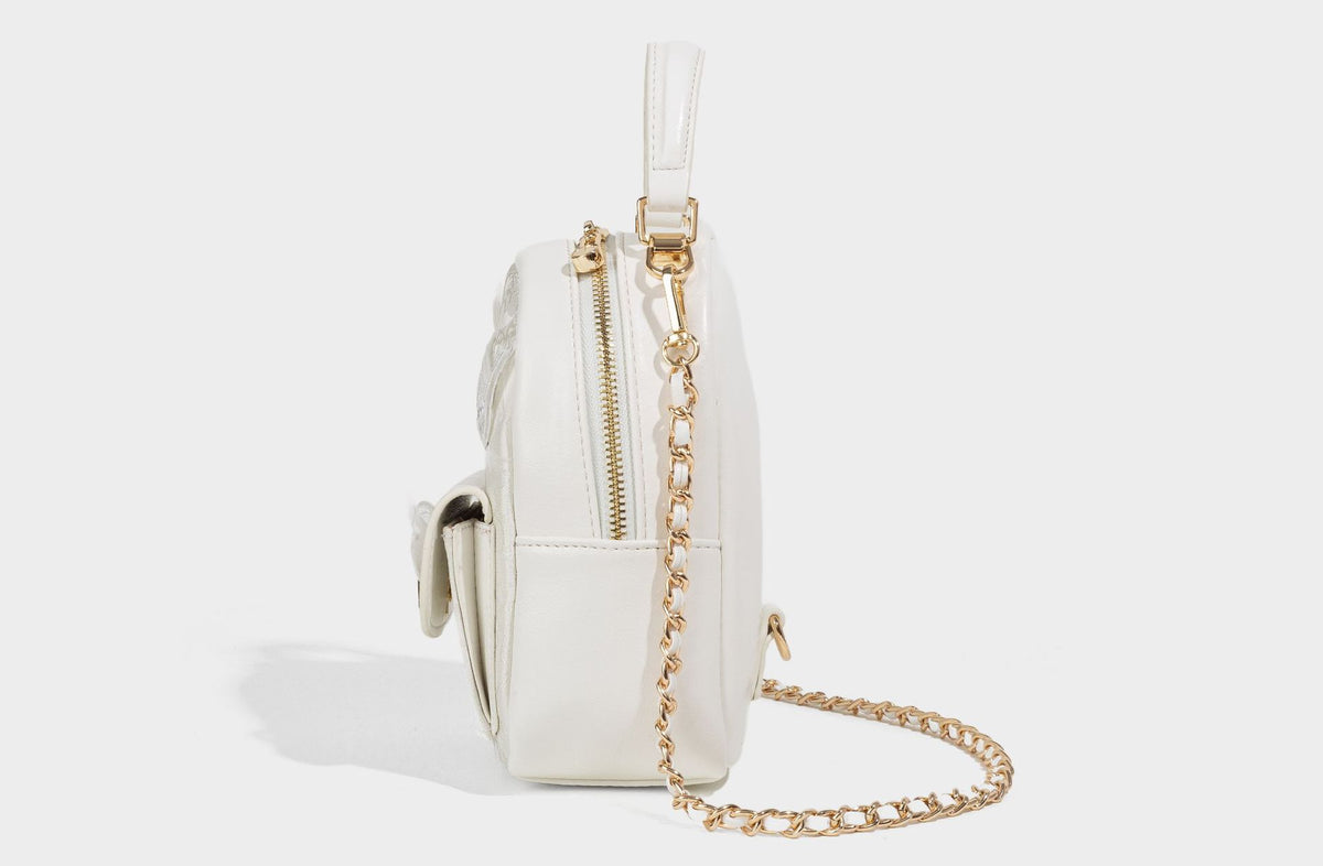 Structured mini backpack handbag with butterfly embroidery, gold-tone chain strap, and turn-lock front flap pocket, detail