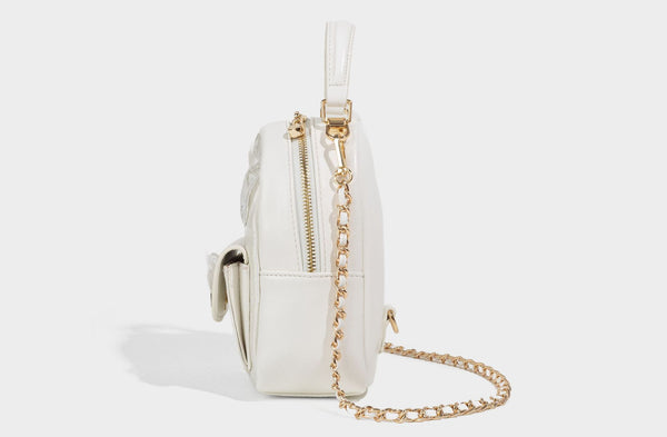 Structured mini backpack handbag with butterfly embroidery, gold-tone chain strap, and turn-lock front flap pocket, detail
