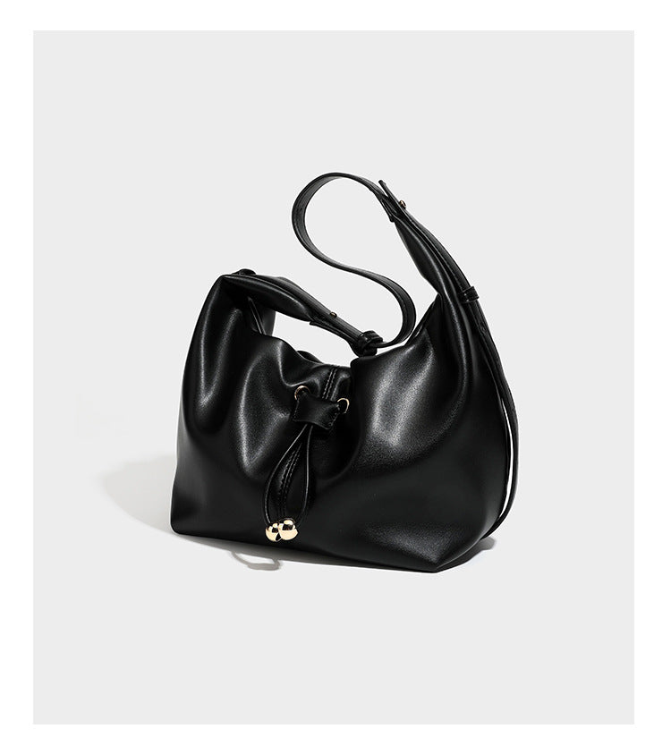 Slouchy hobo bag with smooth leather-look finish, drawstring cinch closure, and gold-tone bead hardware, detail view 13