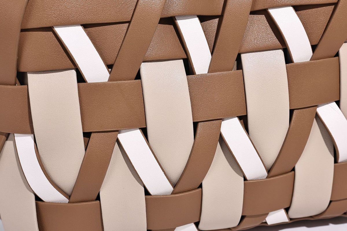 Small structured woven lattice tote bag with dual top handles and detachable shoulder strap in brown and cream leather-look