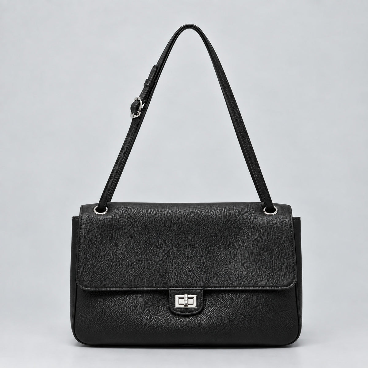 Structured black flap shoulder bag with pebbled texture, silver-tone turn-lock closure, and adjustable single shoulder strap