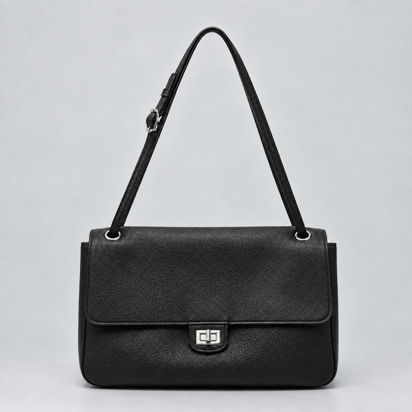 Structured black flap shoulder bag with pebbled texture, silver-tone turn-lock closure, and adjustable single shoulder strap