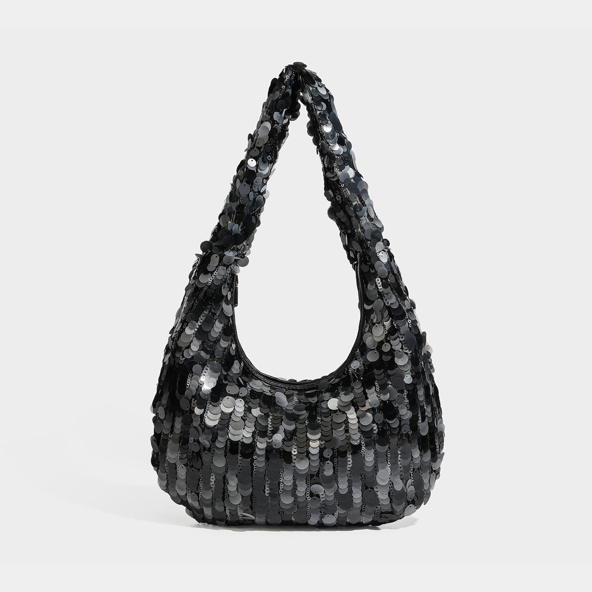 Slouchy crescent hobo shoulder bag covered in overlapping reflective sequin discs with a single integrated strap and top-zip