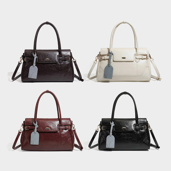 Structured glossy leather-look satchel bag with flap closure, gold-tone buckle accents, double top handles, detachable