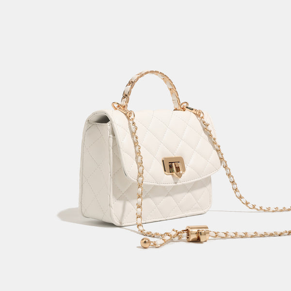 Small structured quilted flap crossbody bag with gold-tone turn-lock closure and chain strap, detail view 3