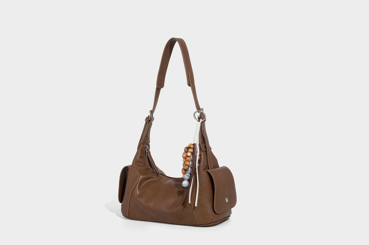 Soft pebbled leather-look hobo shoulder bag with zip top closure, side flap pockets, and silver-tone hardware, detail view 28