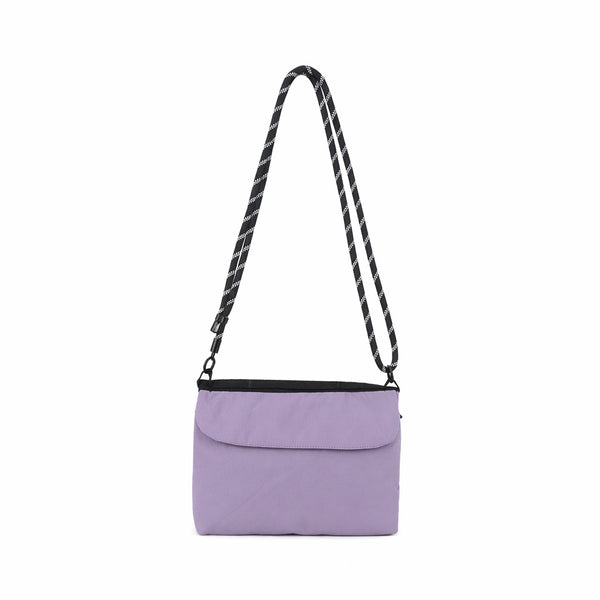 Flat rectangular crossbody bag with mesh front pocket, top zip closure, and adjustable patterned strap, detail view 6