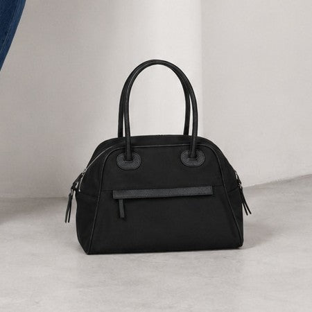 Structured dome top-handle bag in matte nylon with pebbled vegan leather-look trim, zip-top closure, front slip pocket, and