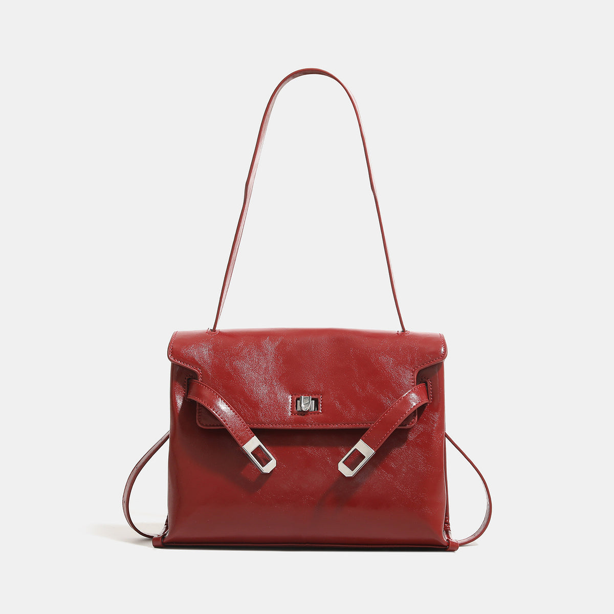 Structured rectangular flap shoulder bag in glossy leather-look finish with silver turn-lock clasp and adjustable strap