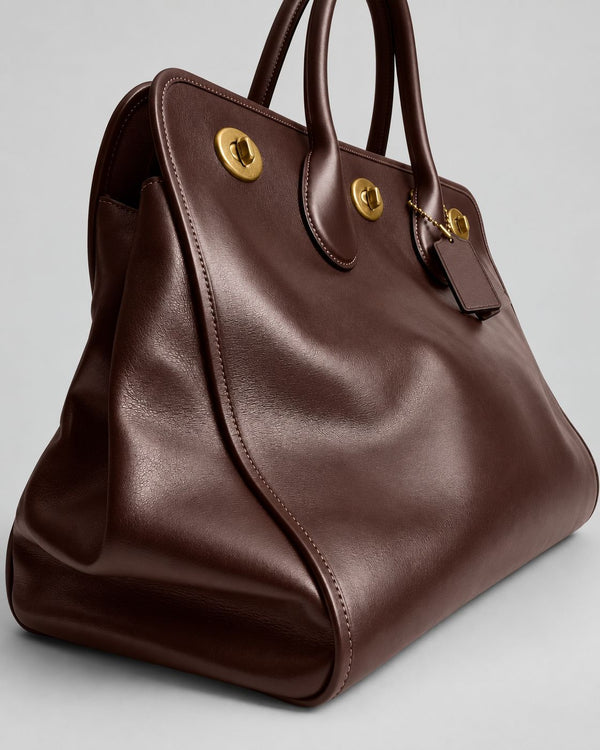 Structured leather-look tote bag with three gold-tone turn-lock closures and double rolled top handles, detail view 22