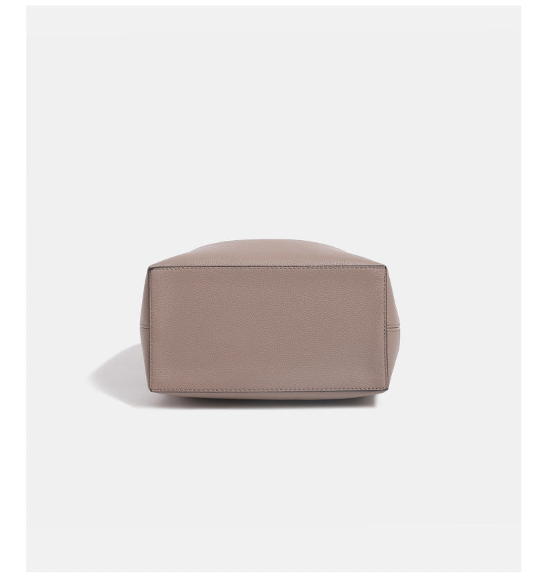 Structured pebbled leather-look bucket bag with gold-tone turn-lock clasp and looped top handle, detail view 15
