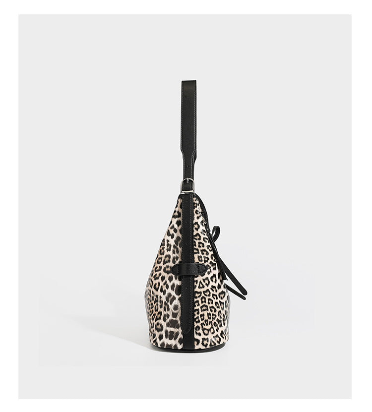 Slouchy leopard print shoulder hobo bag with black leather-look trim, tie-top closure, and single long strap, detail view 8