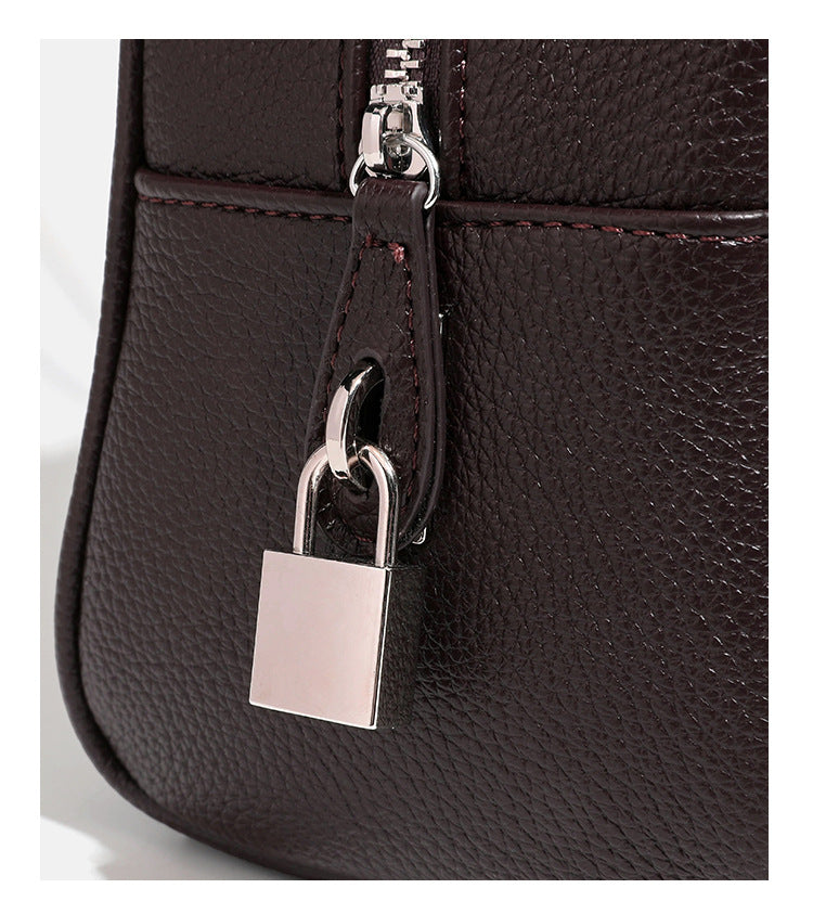 Structured rounded rectangular shoulder bag with pebbled leather-look finish, dual long handles, top zipper, front zip