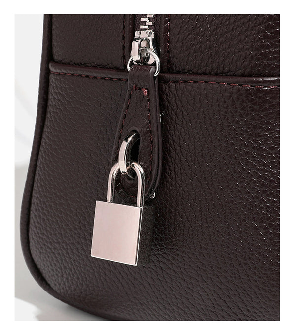 Structured rounded rectangular shoulder bag with pebbled leather-look finish, dual long handles, top zipper, front zip