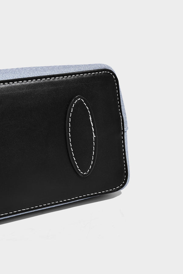 Structured light-blue denim-look tote bag with black leather-look handles, white contrast stitching, silver-tone hardware