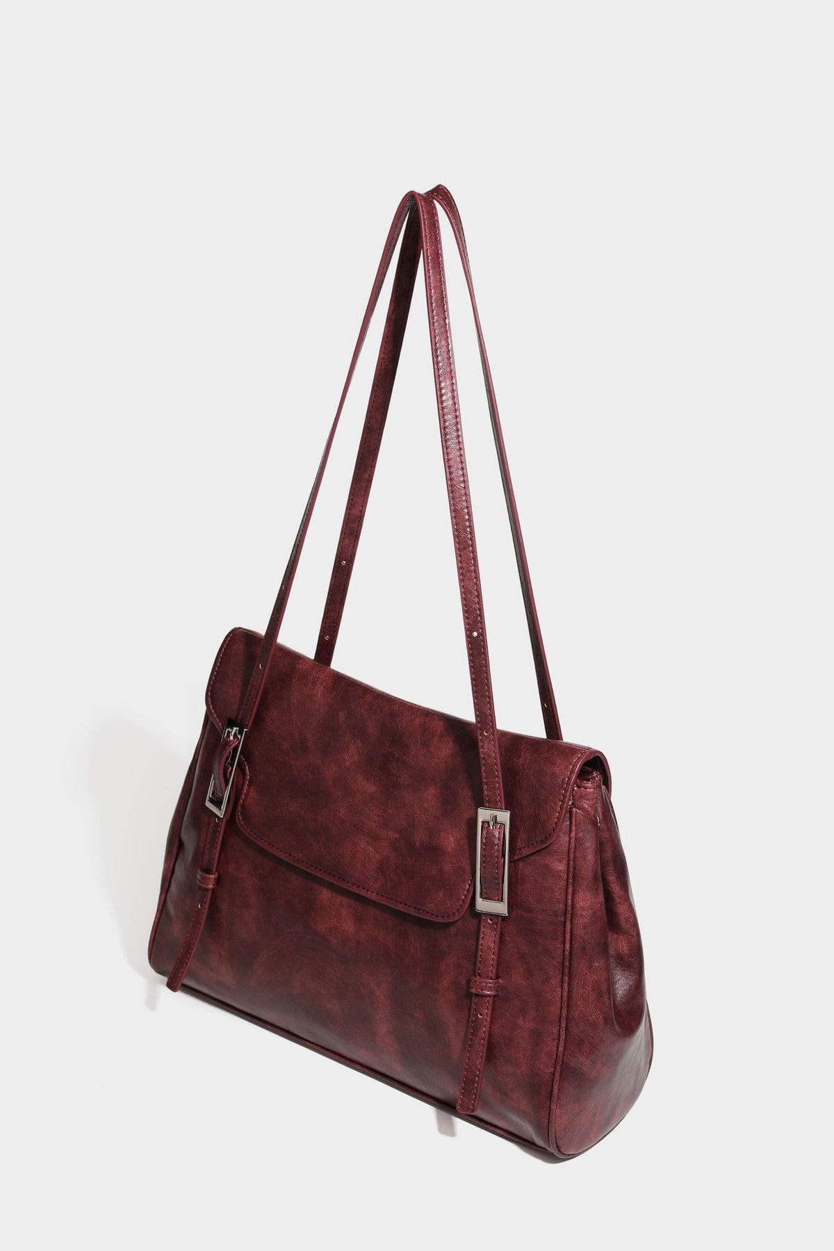 Structured flap-top shoulder tote bag in distressed leather-look finish with silver-tone buckle hardware and double shoulder