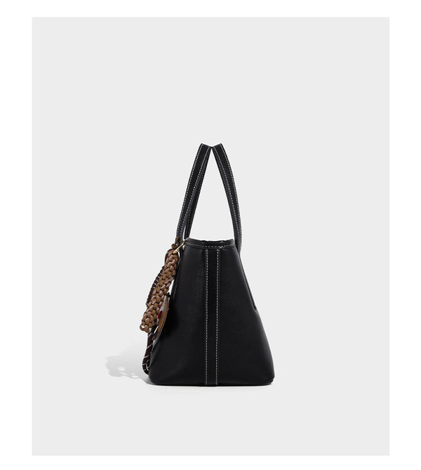 Compact structured bucket tote bag with pebbled textured finish, dual top handles, silver-tone lock hardware, and detachable
