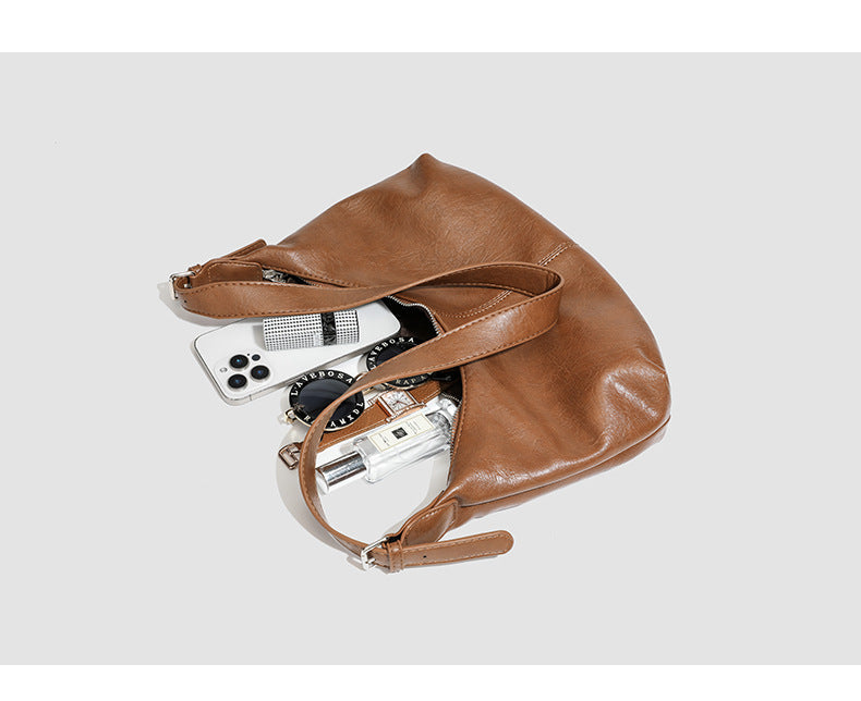 Slouchy crescent hobo shoulder bag with zip-top closure and adjustable strap, detail view 10