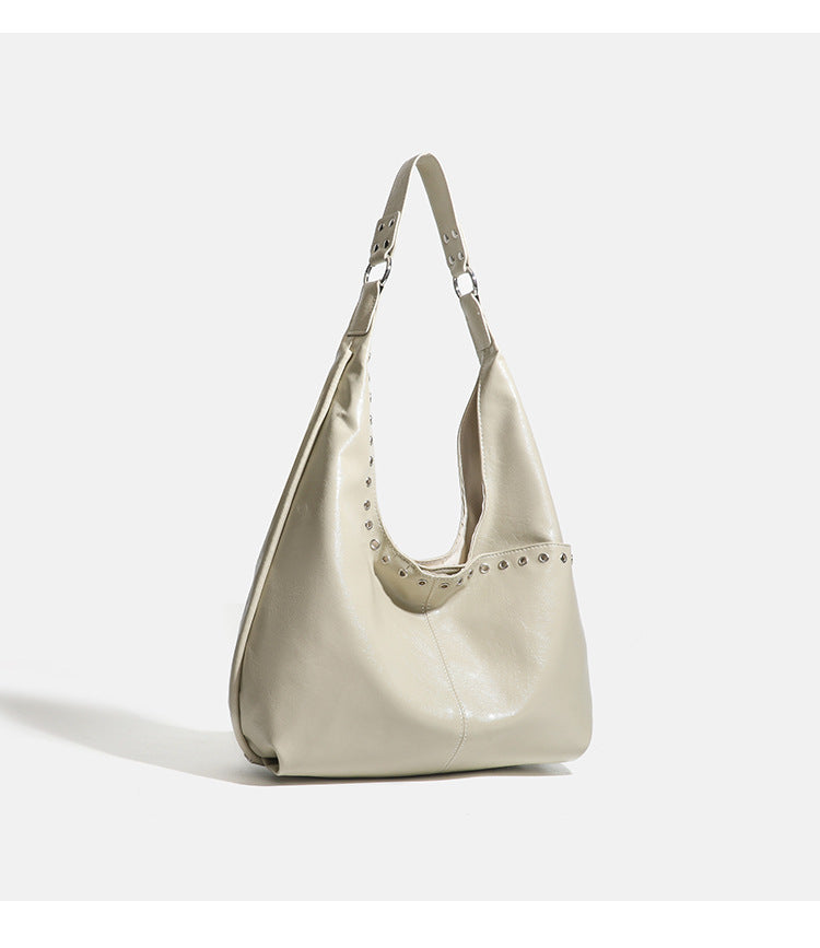 Large slouchy hobo shoulder bag with silver eyelet trim and glossy leather-look finish, detail view 11