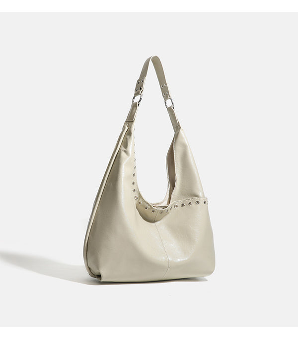 Large slouchy hobo shoulder bag with silver eyelet trim and glossy leather-look finish, detail view 11